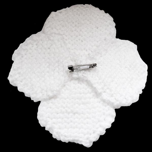 Hand knitted brooch in white with purple pearl